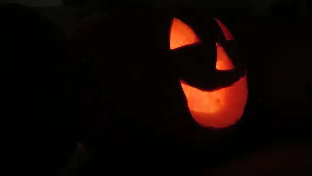 A jack-o'-lantern by candlelight